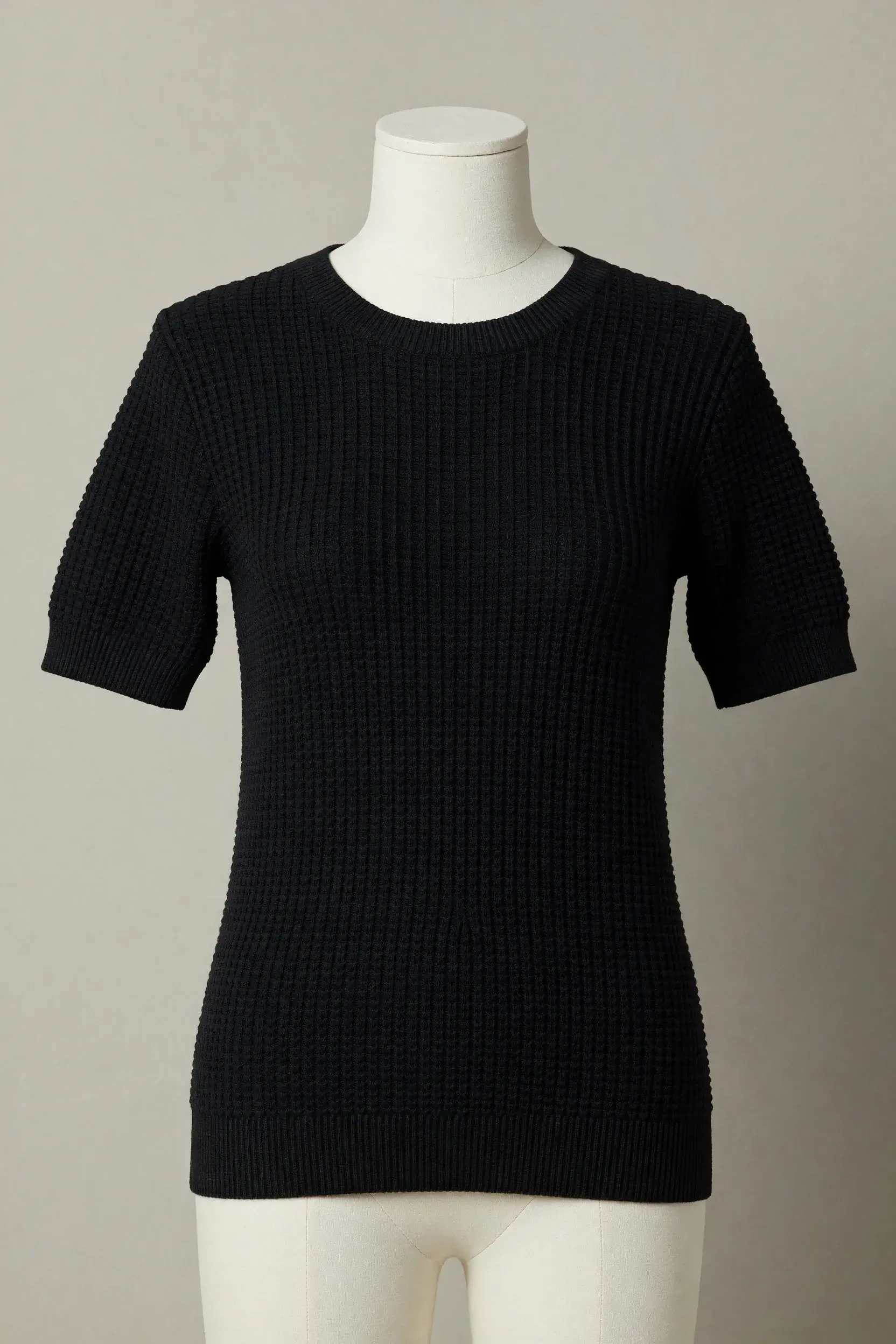 Black square-textured waffle-knit crewneck short-sleeve tee on a mannequin for private-label product development