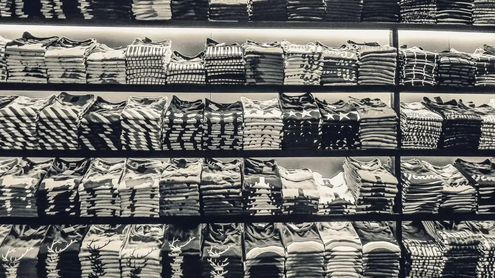 Shelves filled with folded ready-stock shirts