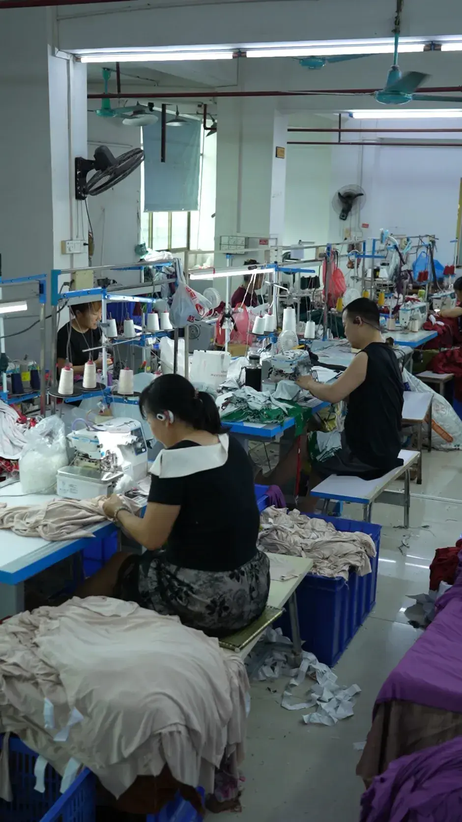 A sewing operator working at an industrial machine on the Cynida production floor