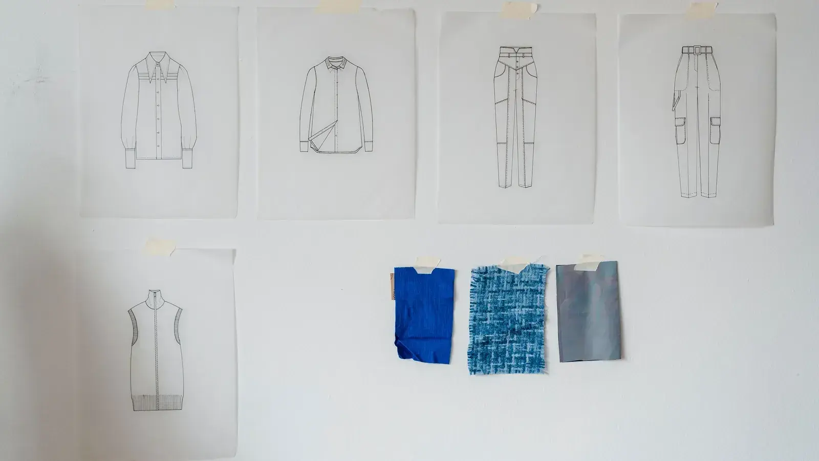 Technical garment sketches and fabric swatches arranged for sample development