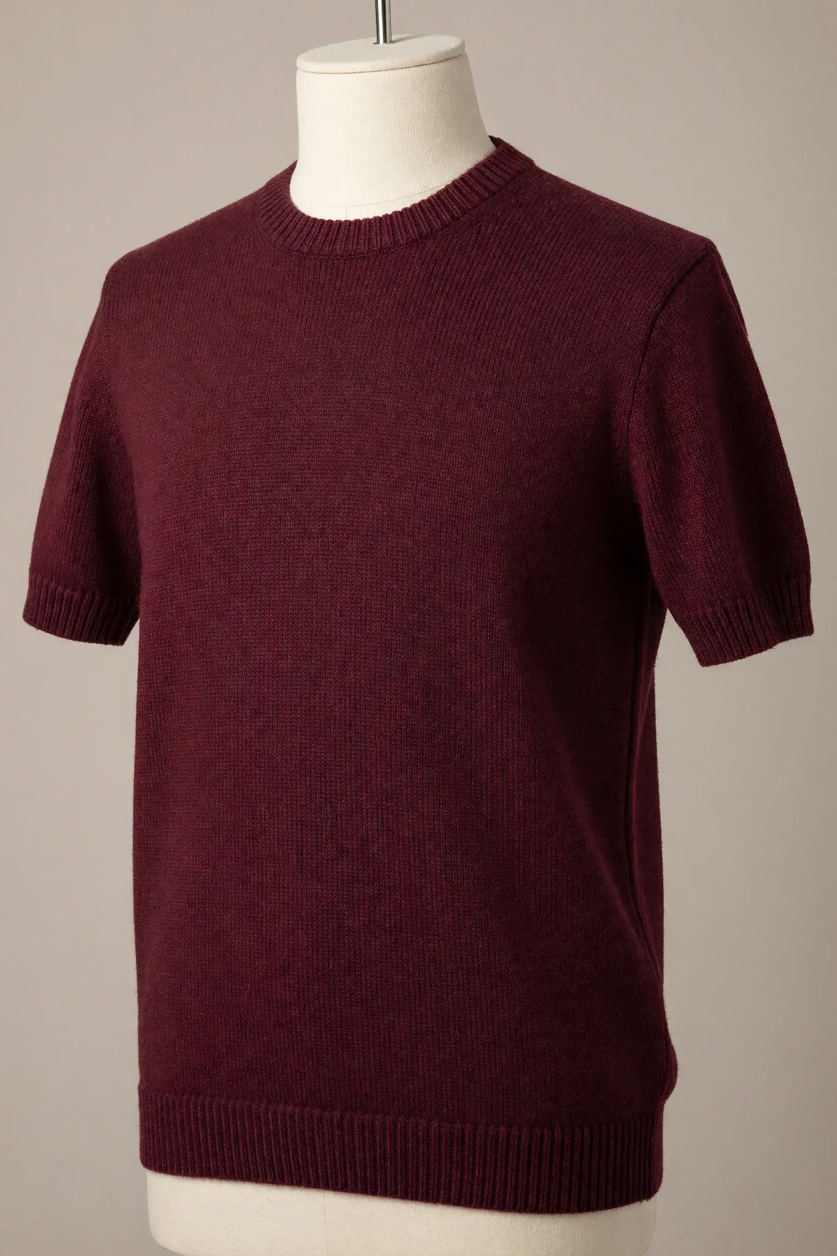 Burgundy crew-neck short-sleeve knit tee with prominent ribbing at the collar, cuffs and hem displayed on a torso mannequin for private-label production