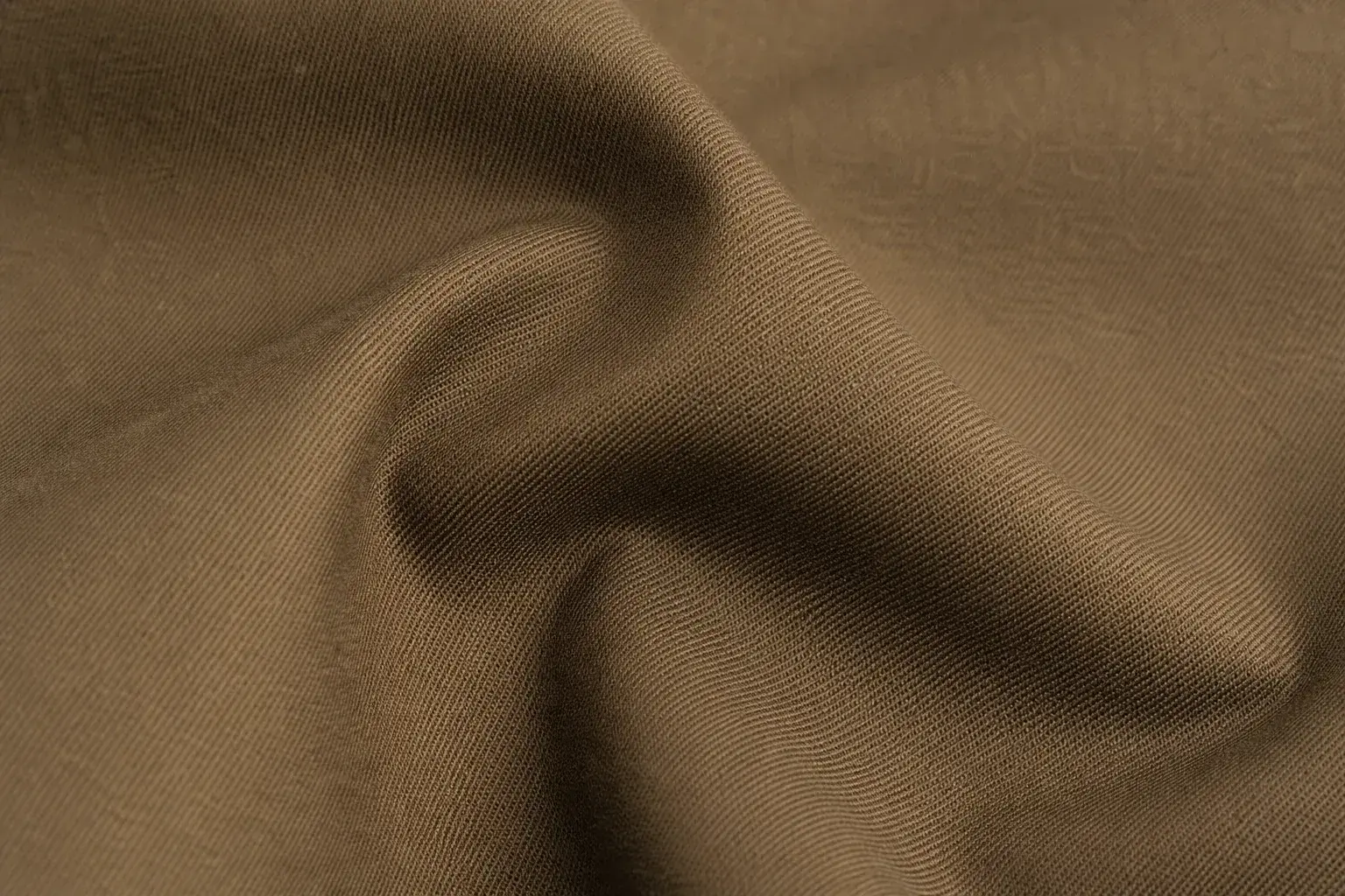 Tobacco stretch-cotton trouser fabric folded to show density and recovery