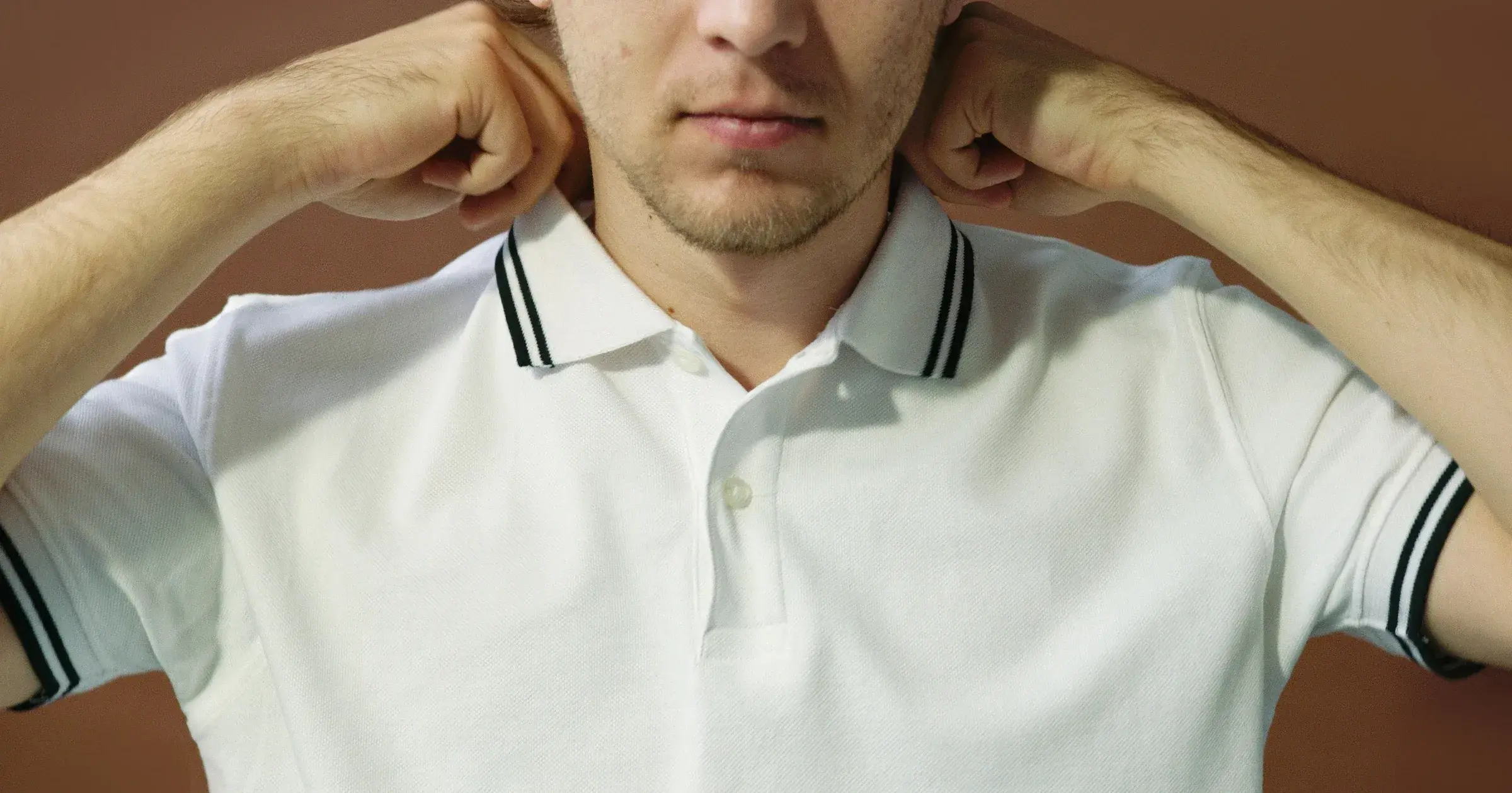 Close-up of a white polo shirt with a tipped rib-knit collar and button placket