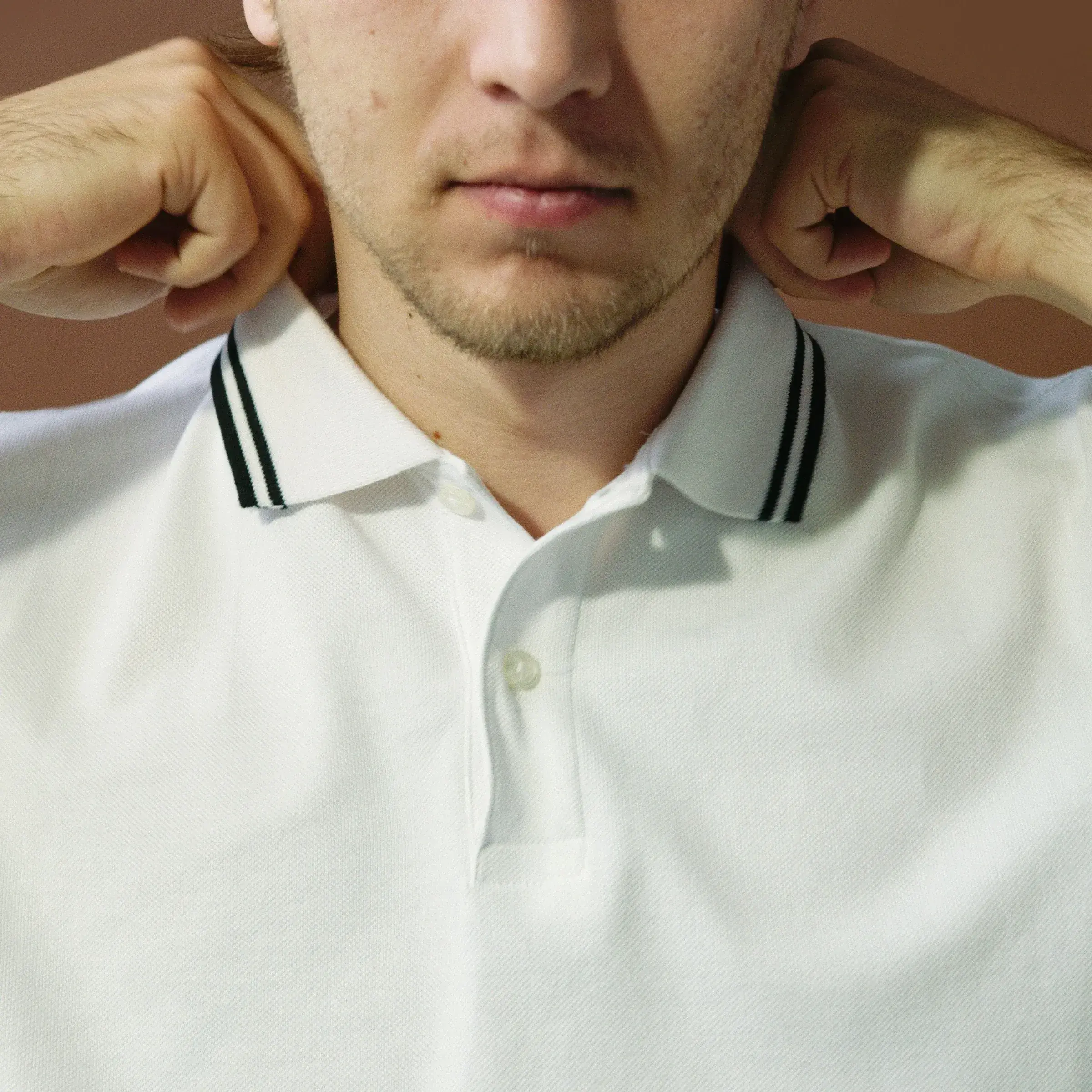 Close-up of a white polo shirt collar and two-button placket
