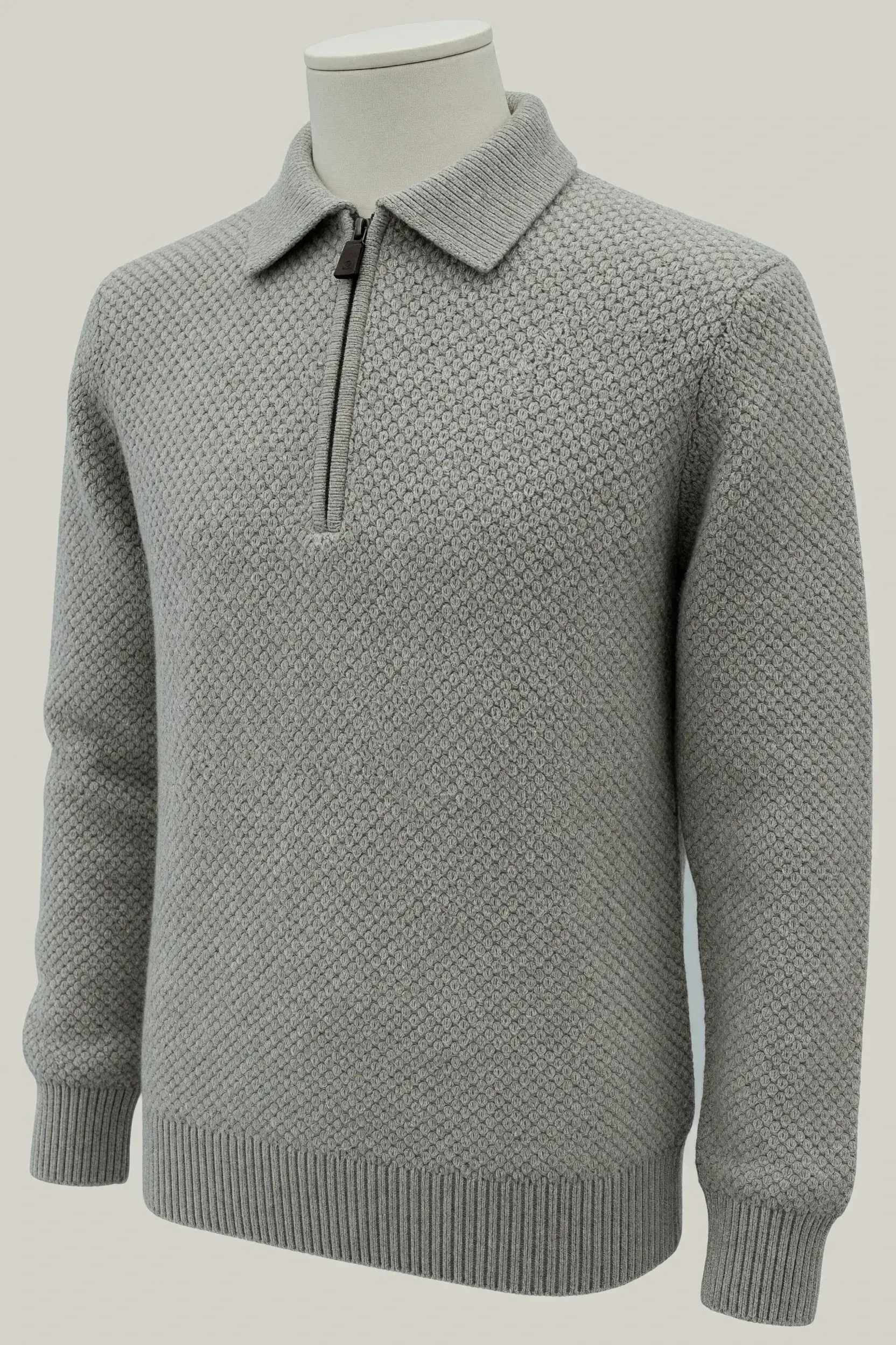 Silver grey seed-stitch zip-collar sweater shown on a headless mannequin for OEM private-label knitwear development