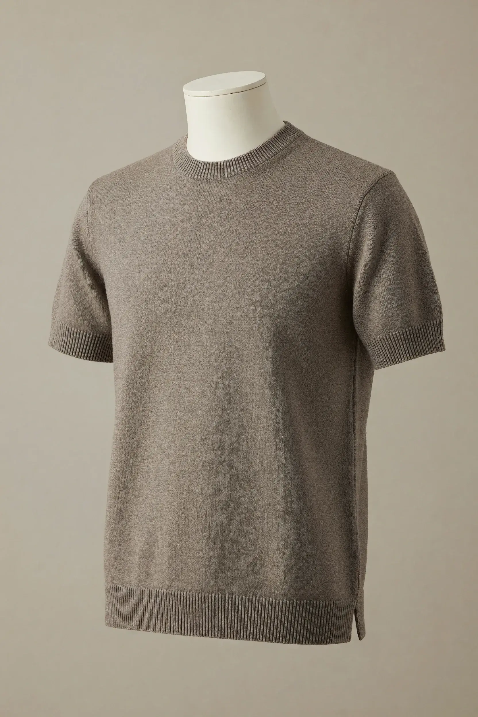 Taupe crew-neck short-sleeve knit tee with ribbed cuffs, rib hem and visible side splits displayed on a neutral torso mannequin for private-label development