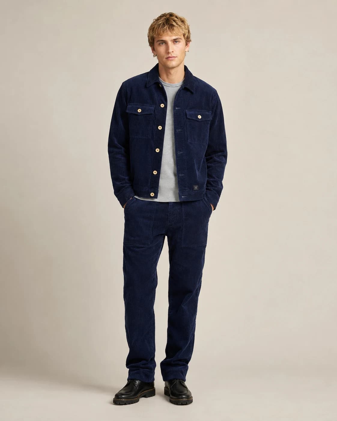 Model wearing a navy corduroy jacket and pants for smart casual menswear manufacturing
