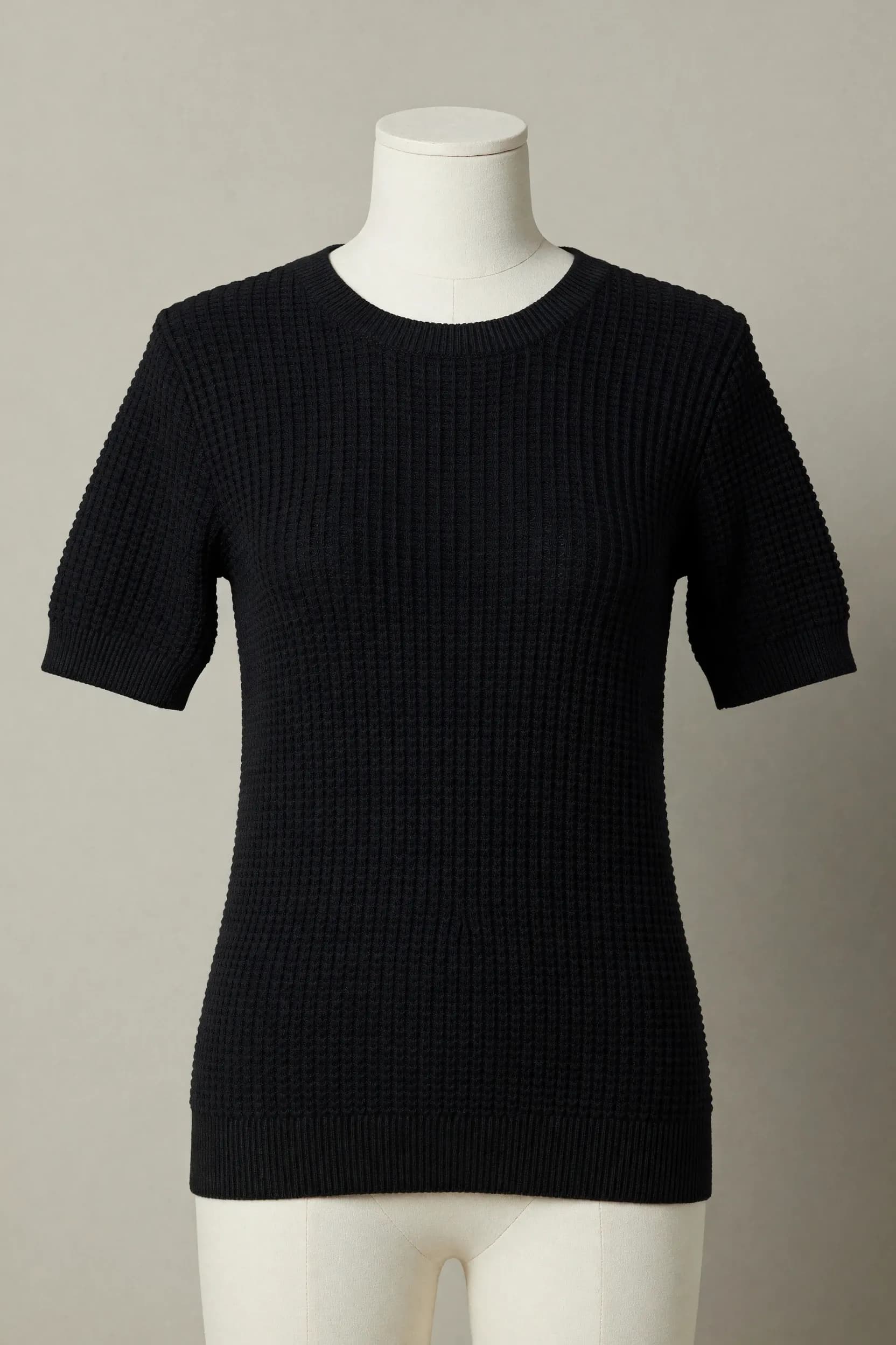Black square-textured waffle-knit crewneck short-sleeve tee on a mannequin for private-label product development