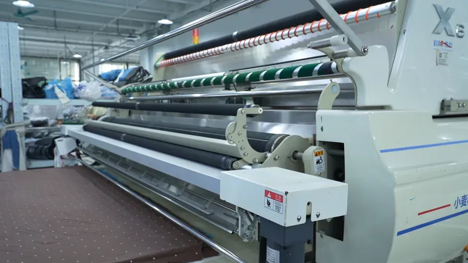 An automatic fabric spreading machine on the Cynida cutting floor