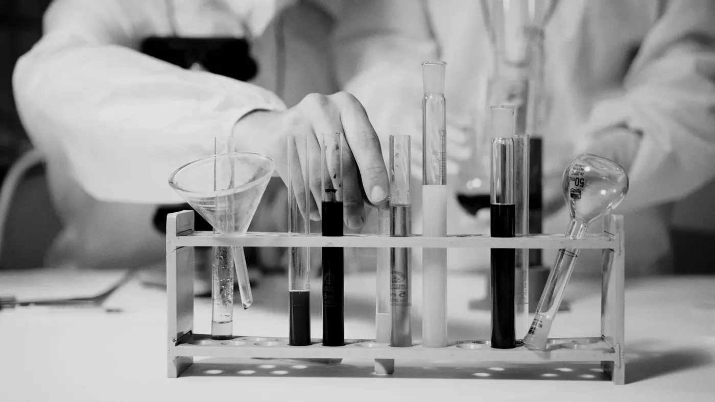 Laboratory glassware and test tubes arranged on a rack