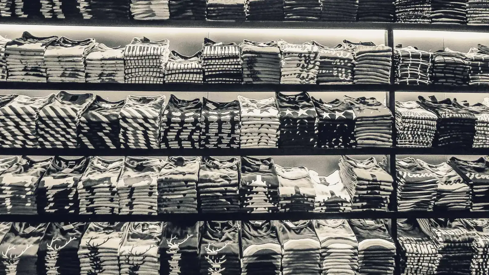 Shelves filled with folded ready-stock shirts