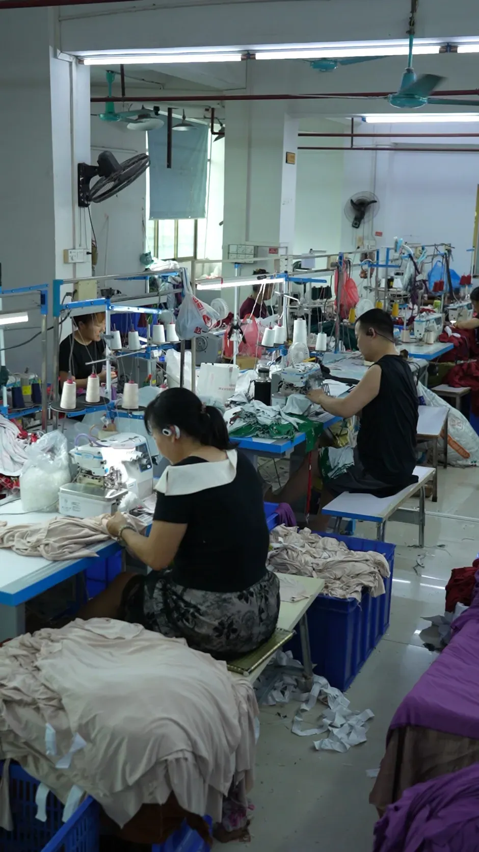 A sewing operator working at an industrial machine on the Cynida production floor