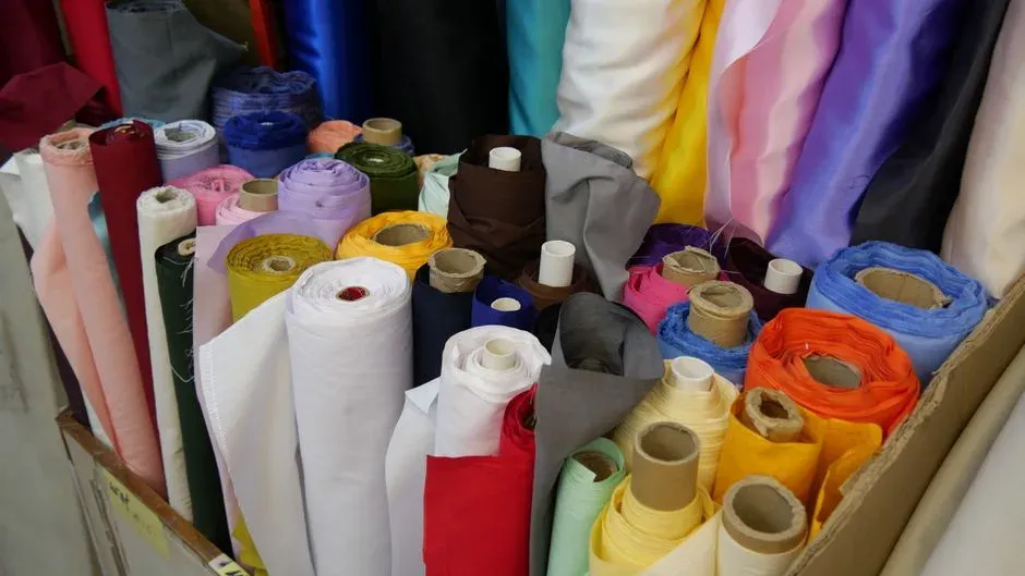 Rolls of colorful fabric stacked in a textile shop