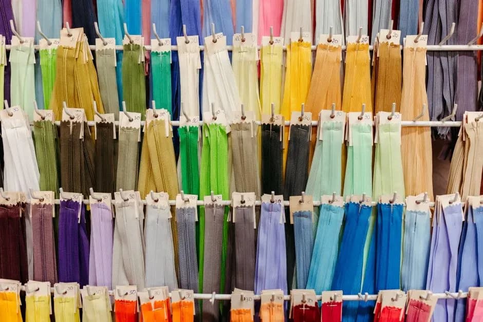 Rows of colorful zippers hanging on display hooks