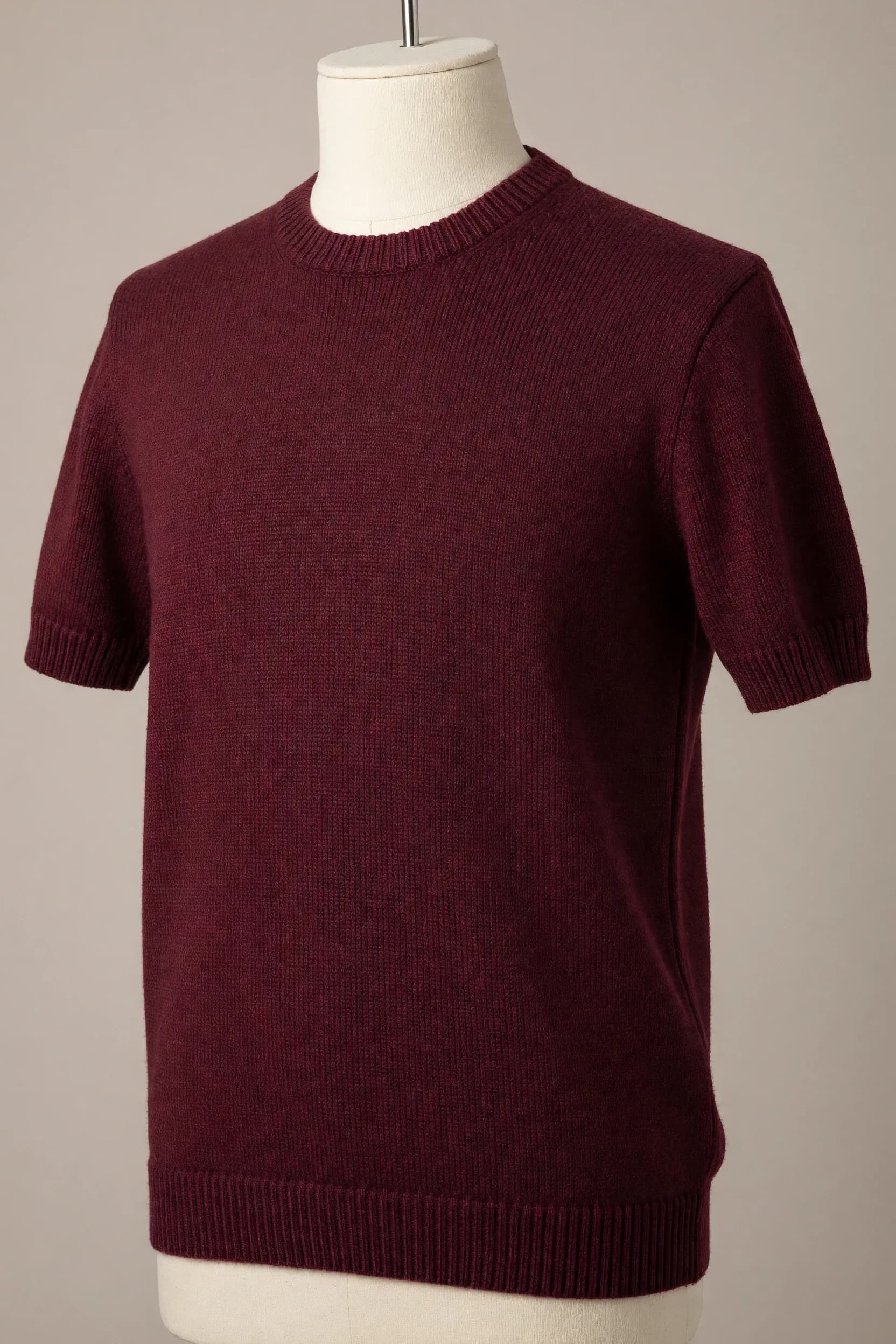 Burgundy crew-neck short-sleeve knit tee with prominent ribbing at the collar, cuffs and hem displayed on a torso mannequin for private-label production