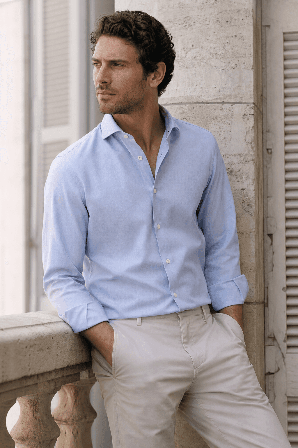 Man wearing a light blue smart-casual button-down shirt and beige trousers for OEM shirt manufacturing