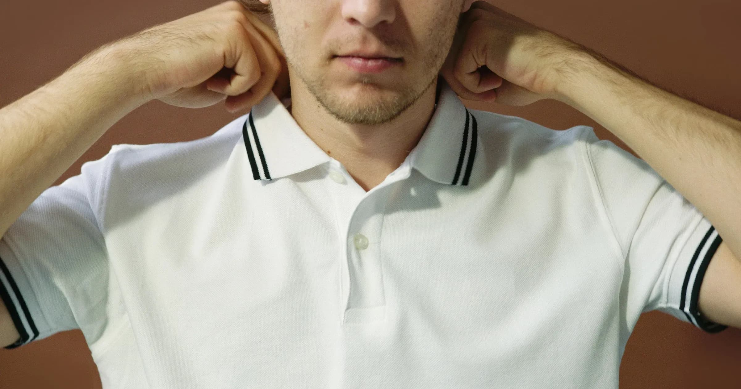 Close-up of a white polo shirt with a tipped rib-knit collar and button placket