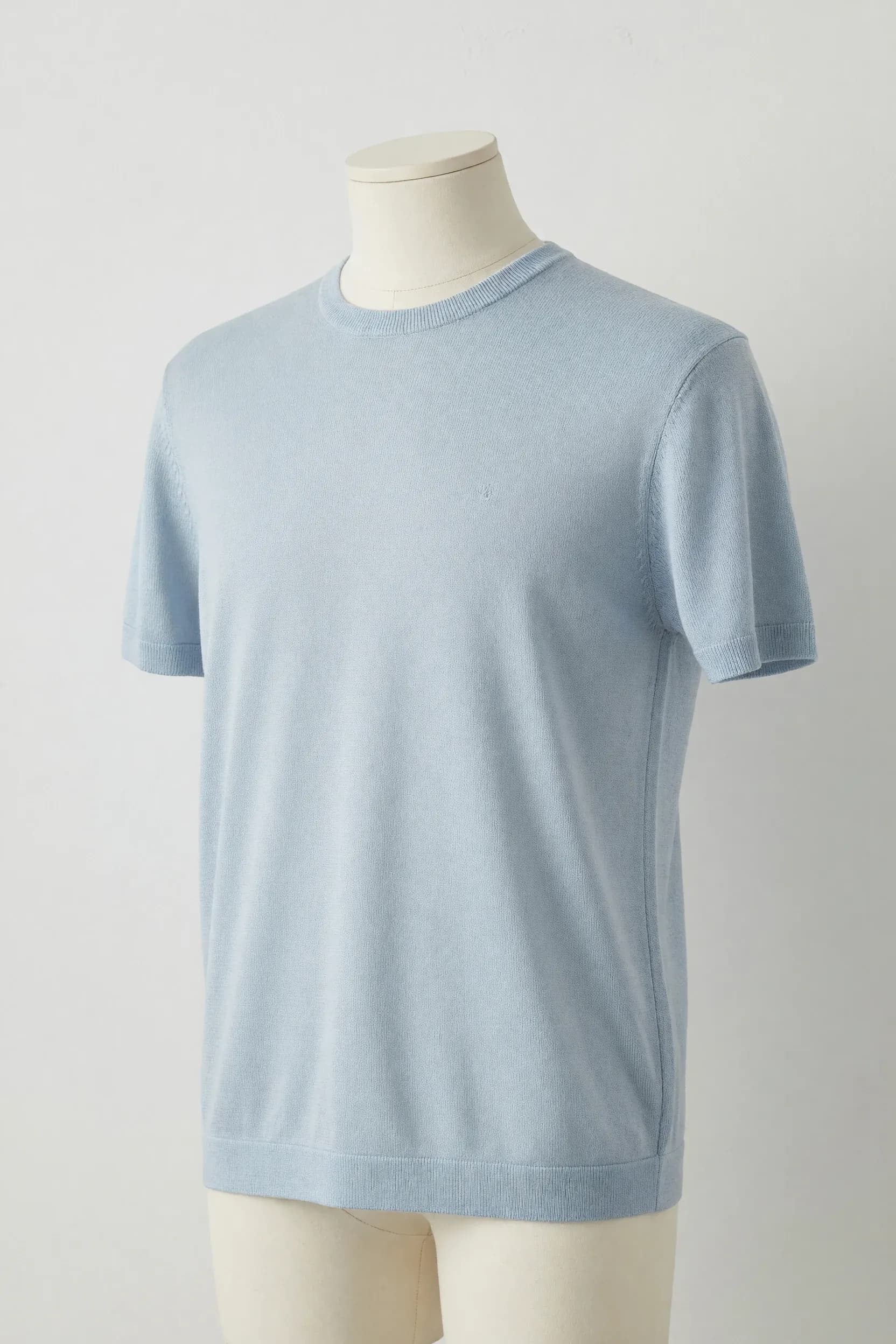 Sky blue narrow-rib crewneck knit tee displayed on a torso mannequin for private-label knitwear development