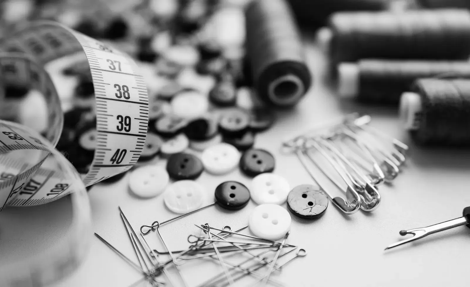 Threads and sewing tools representing garment construction and trim variables