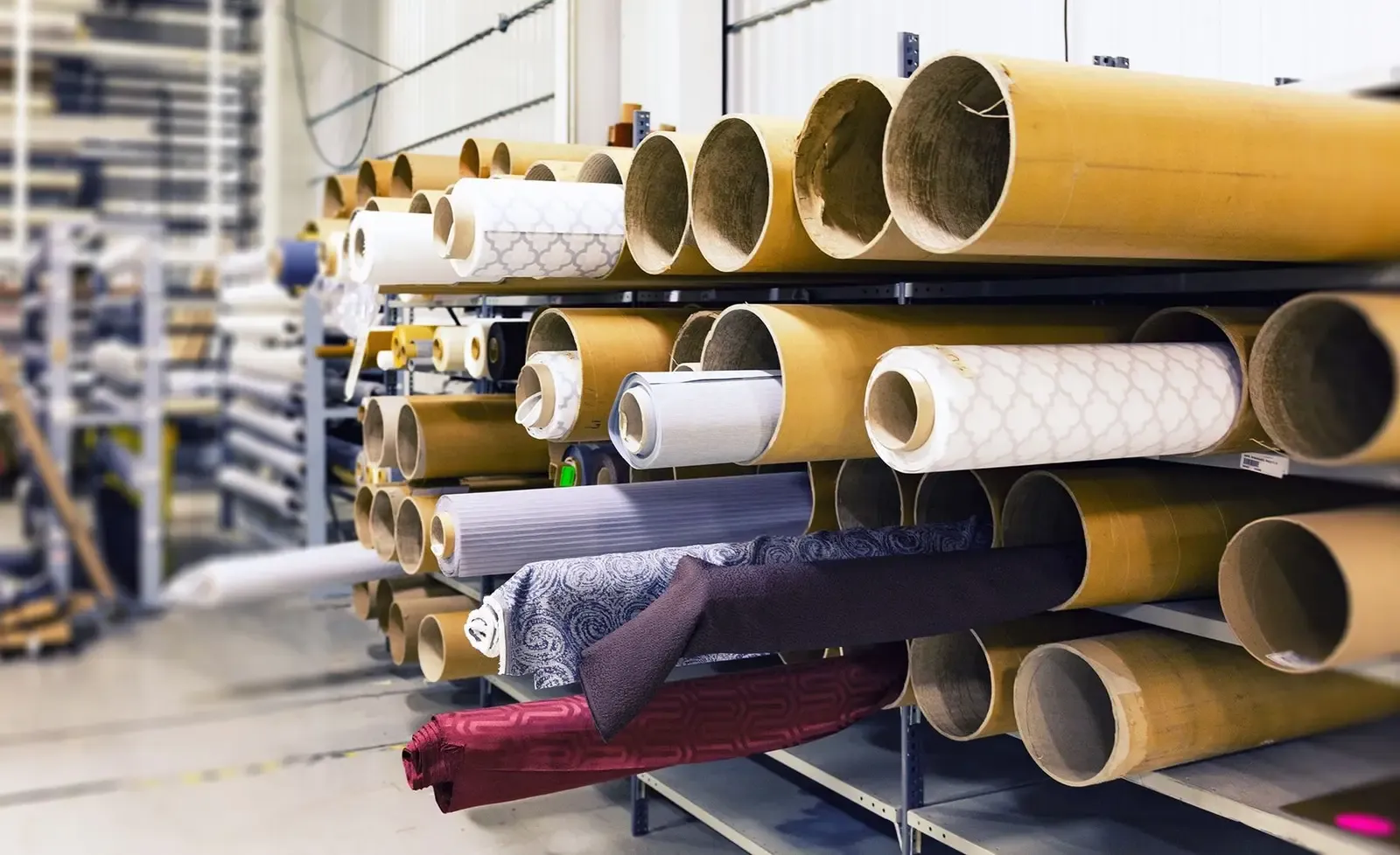 Rolls of textile stored together before garment production