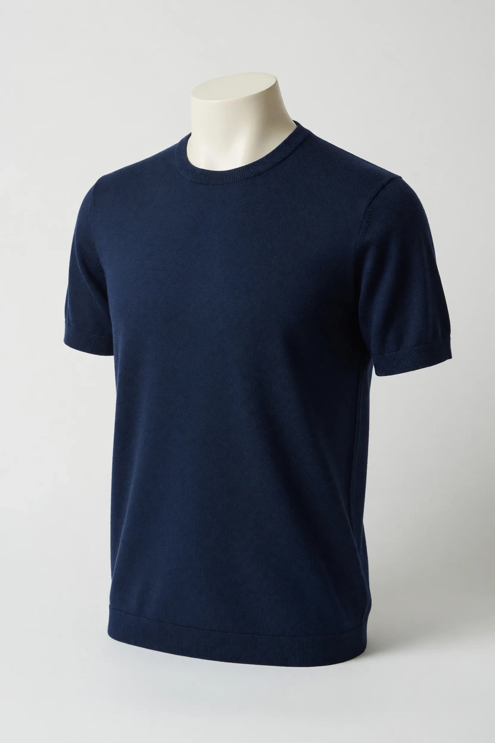 Navy minimal crewneck short-sleeve knit tee with narrow rib collar and sleeve edges on a mannequin for private-label development