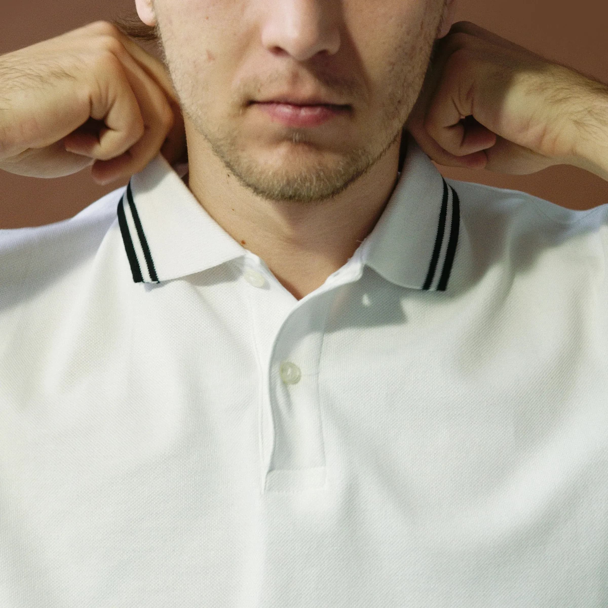 Close-up of a white polo shirt collar and two-button placket