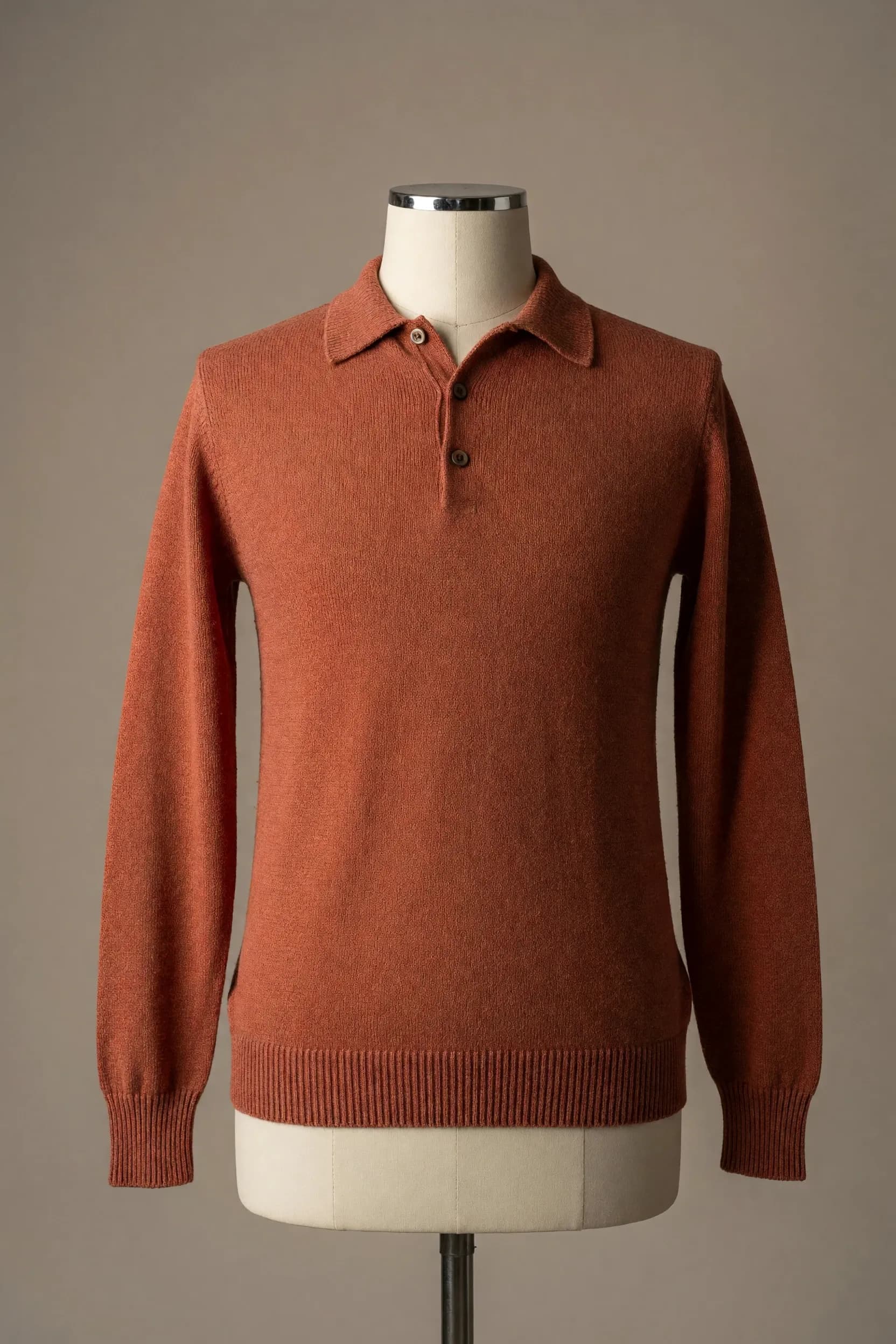 Rust orange long-sleeve three-button knit polo sweater displayed on a mannequin for OEM private-label range development