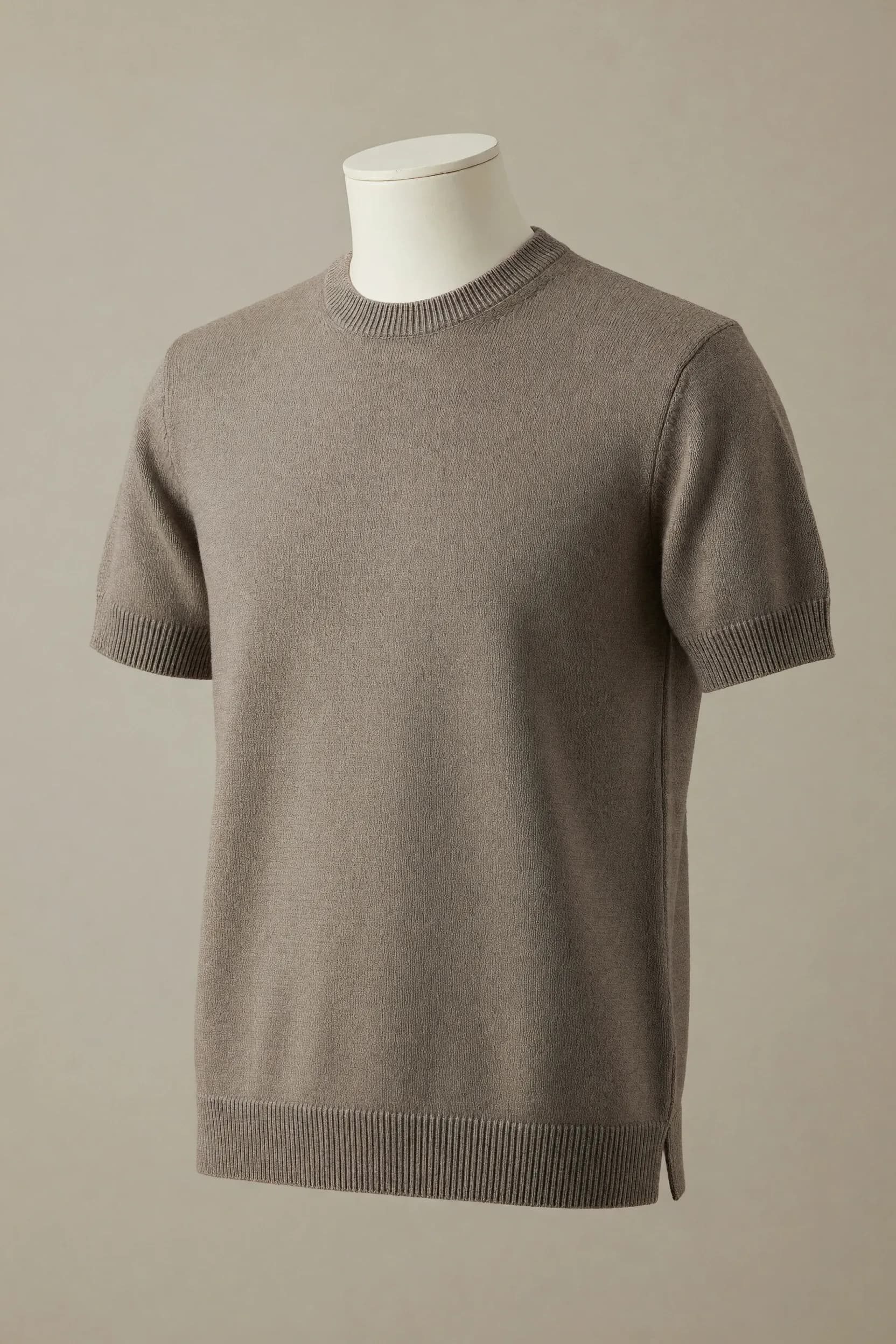 Taupe crew-neck short-sleeve knit tee with ribbed cuffs, rib hem and visible side splits displayed on a neutral torso mannequin for private-label development